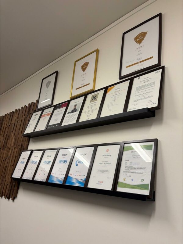 A collection of official certificates and professional diplomas displayed in a clean, organized arrangement.