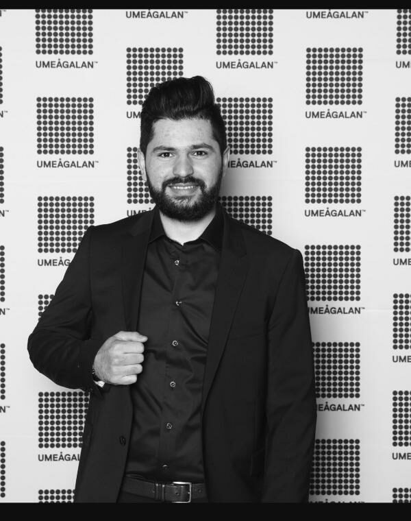 Person in a classic black formal suit